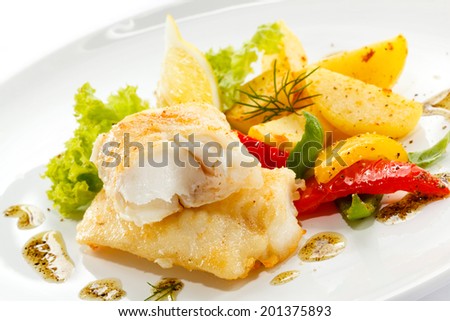 Fish dish - fried fish, fried potatoes and vegetables
