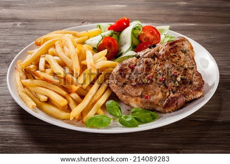 Steak, French fries and vegetables