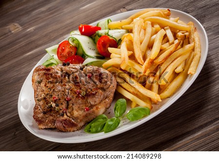 Steak, French fries and vegetables