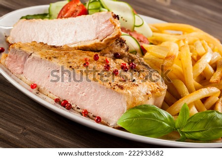 Fried pork chop, chips and vegetable salad