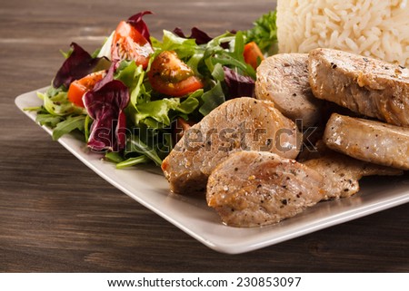Fried pork loin,white rice and vegetable salad