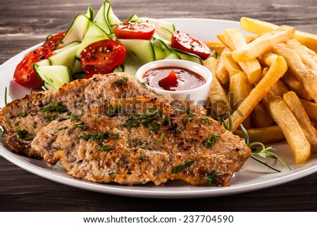 Pork chops, French fries and vegetables