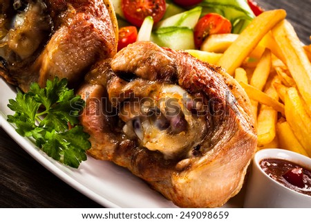 Grilled turkey legs with chips and vegetables