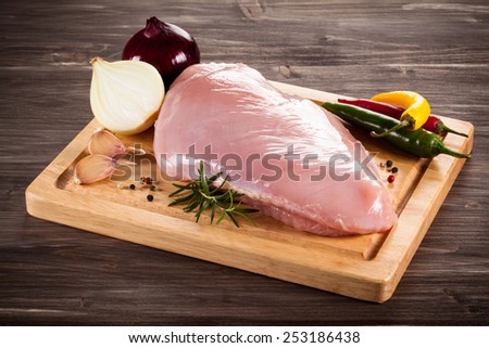 Raw turkey fillet on cutting board