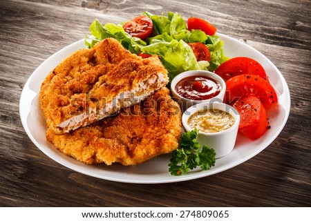 Fried pork chops and vegetable salad