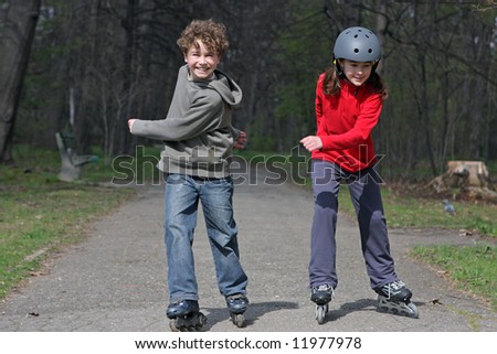 Young girl and boy on roller blades