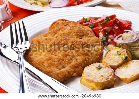 Fried chop pork with potatoes and vegetable salad
