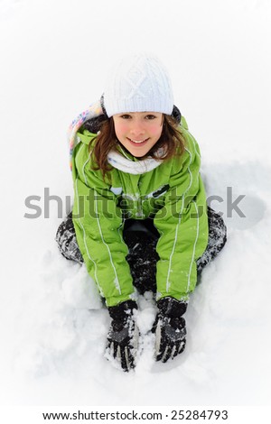 Young girl playing in snow
