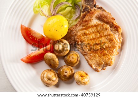 Grilled steaks with mushrooms and vegetable salad