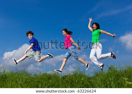 Happy family jumping, running outdoor