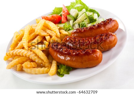 Grilled sausages with chips and vegetables
