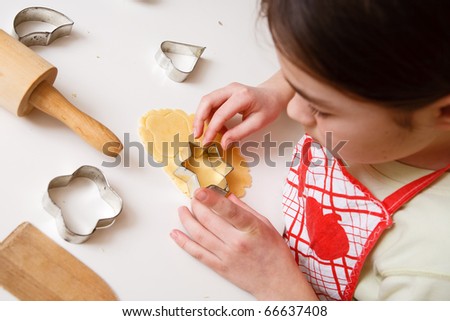 Young girl making cakes