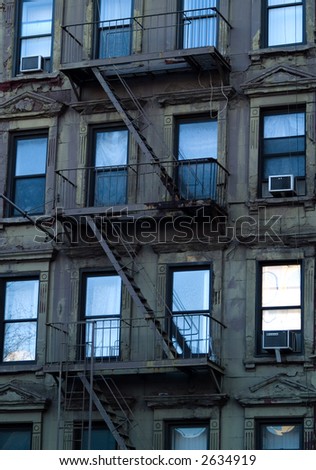 Windows and escape ladders on a New York apartment building.