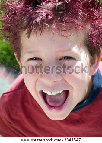 Little boy with crazy hair winks at the camera