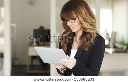 Mature Businesswoman with Digital Tablet in Office