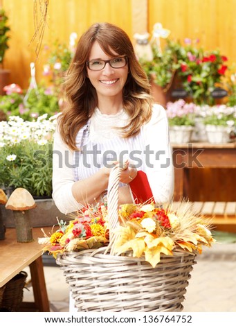 Smiling Mature Woman Florist Small Business Flower Shop Owner. Shallow Focus.