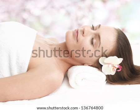 Close-up portrait of happy lady relaxing in massage salon