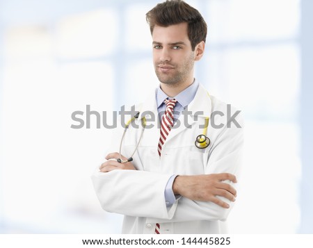 Caring doctor smiles confidently in hospital