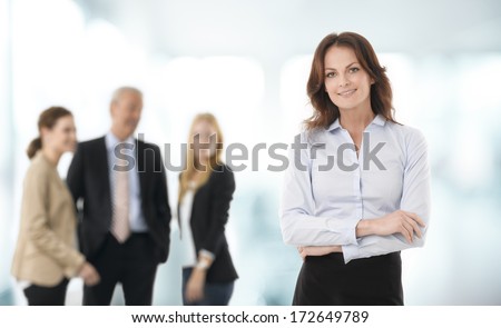 Beautiful Businesswoman Standing, People In The Background.