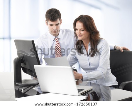 Businessmen working together with his colleague in office