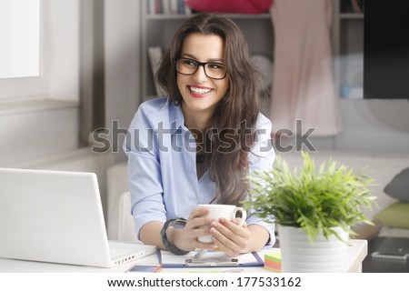 Young fashion designer working in her studio Young fashion designer working in her studio