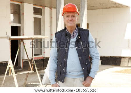 Construction worker standing on the construction site. Small business.