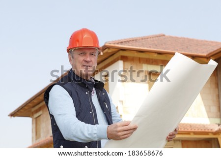 Senior architect standing in front of building. Small business.