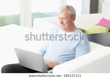 Close-up of active senior man working at home. Small business.