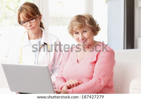 Close-up of happy female doctor consulting  with senior patient at small clinic.