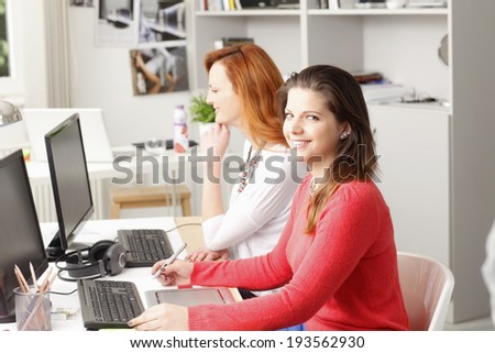 Young businesswoman working at small graphic designer studio.