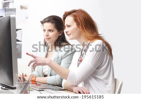 Modern graphic designer woman working with colleagues in office. Small business.