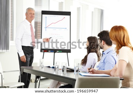 Senior businessman presentation his idea at meeting. Business group.