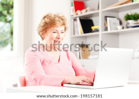 Portrait of senior woman surfing on internet.