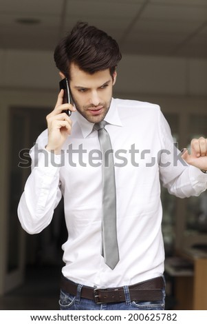 Young businessman holding handy in his hand. Small business.