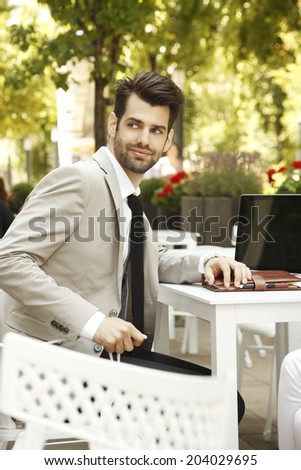 Modern businessman portrait working online, while sitting in coffee shop. Small business.