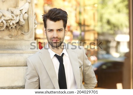 Modern young businessman portrait, while sitting in coffee shop. Small business.