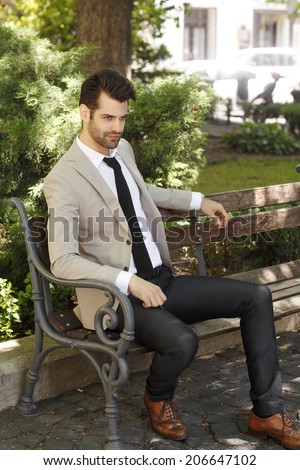 Modern businessman relaxing in front of business center. Business People.