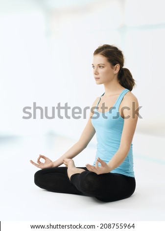 Young female woman in lotus position. Yoga instructor.