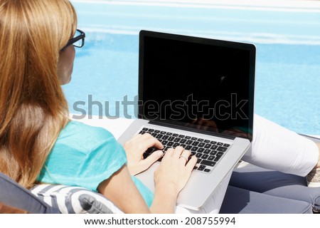 Modern business woman sitting at garden and working at home. Small business.
