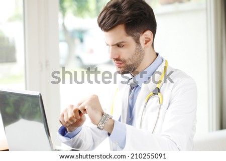 Modern male doctor working in private clinic.