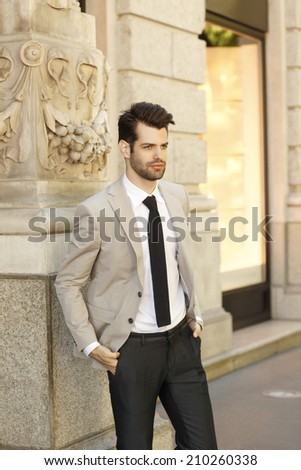 Confident young businessman standing on the street. Business people.