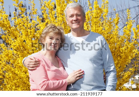 Portrait of senior woman and man standing at garden.  Old people.