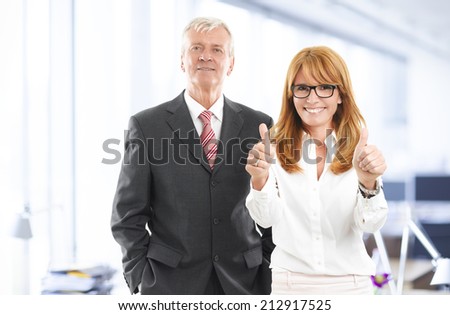 Successful business woman and businessman standing at office. Sales team.