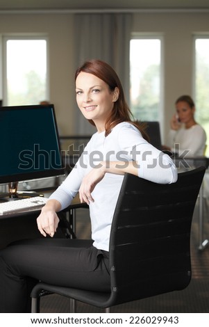Portrait of beautiful middle age business woman standing at office.
