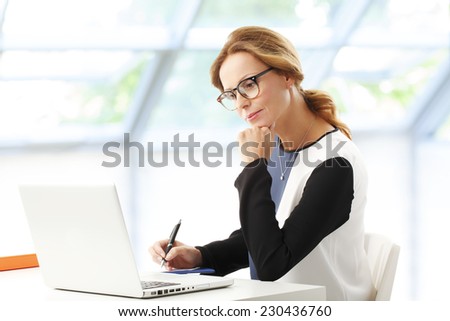Portrait of business woman thinking on solving the problem, while sitting in front of computer. Business people.