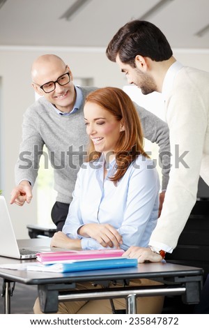 Senior businessman giving advise to sales team while sitting at meeting. Teamwork.