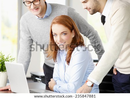 Executive business woman working with business team while working on laptop at office.