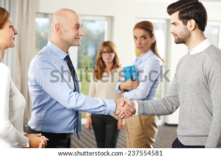 Businessmen shaking hands after closing the deal.