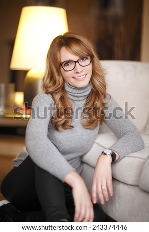 Portrait of successful fashion designer woman sitting at home while taking a break. Small business. Shallow focus.