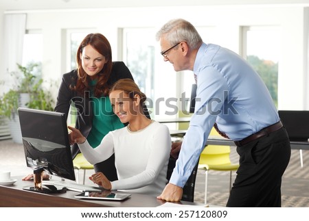 Portrait of executive business woman working together with sales people, while sitting at office in front of laptop.